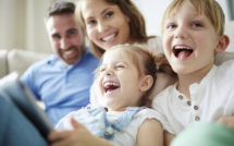 Children sitting together with parents and laughing