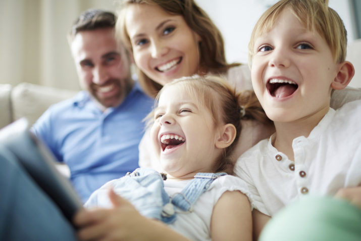 Children sitting together with parents and laughing