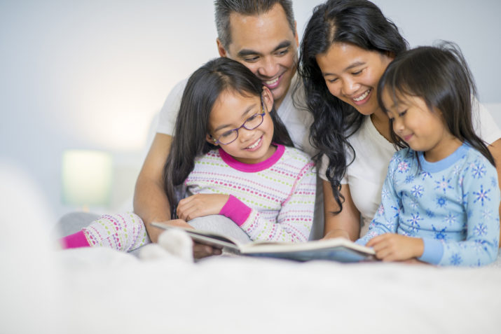parents and children reading in bed