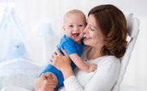 mom holding happy baby