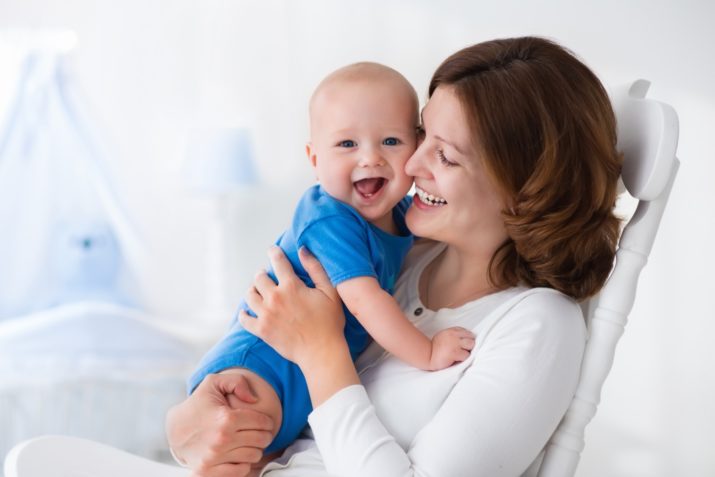 mom holding happy baby