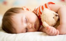 baby sleeping with bear