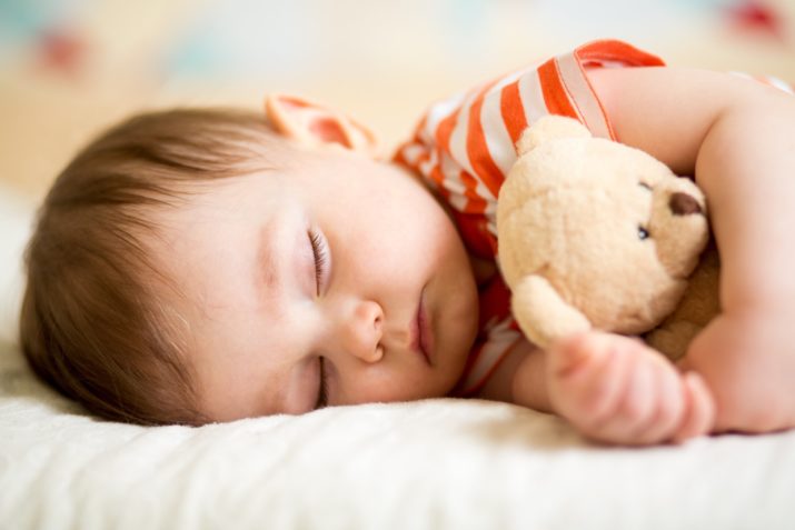 baby sleeping with bear