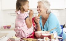 grandmother and granddaughter baking cookies