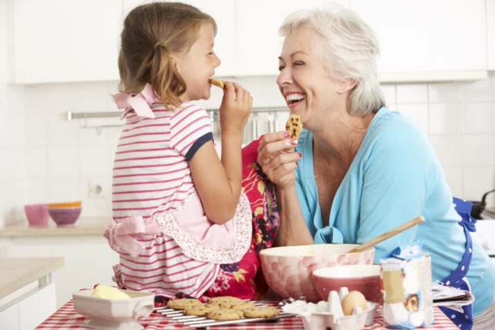 grandmother and granddaughter baking cookies