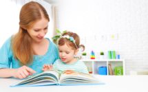 mother and child reading a book together at home