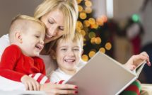 Mother reading Christmas story to happy little boys